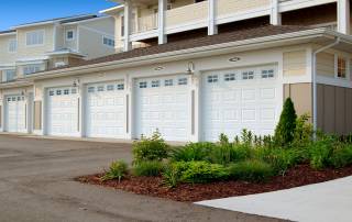 five white garage doors lined up, COMMERCIAL